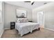 Serene bedroom featuring a comfortable queen bed, calming wall decor, and access to an ensuite bathroom at 33854 Floating Heart Ct, Wesley Chapel, FL 33545