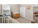 Bedroom with a changing table on the dresser, closet, and a plush glider chair at 33854 Floating Heart Ct, Wesley Chapel, FL 33545