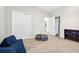 Cozy bedroom featuring a neutral color scheme, carpet flooring, a sofa and a closet at 33854 Floating Heart Ct, Wesley Chapel, FL 33545