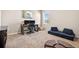 Bright bonus room featuring carpet flooring, a desk, and a comfortable seating area at 33854 Floating Heart Ct, Wesley Chapel, FL 33545