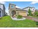 Attractive two-story home with well-maintained lawn and a two car garage at 33854 Floating Heart Ct, Wesley Chapel, FL 33545