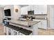 Open concept kitchen with island seating, granite countertops and white cabinets at 33854 Floating Heart Ct, Wesley Chapel, FL 33545