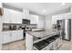 Modern kitchen with white cabinetry, granite countertops and stainless appliances at 33854 Floating Heart Ct, Wesley Chapel, FL 33545