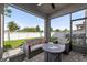 Relaxing screened-in patio with comfortable seating and views of the backyard at 33854 Floating Heart Ct, Wesley Chapel, FL 33545