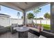 Relaxing screened patio with comfortable seating and a view of the backyard at 33854 Floating Heart Ct, Wesley Chapel, FL 33545