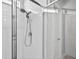 Contemporary walk-in shower with sleek chrome fixtures and tiled walls at 33854 Floating Heart Ct, Wesley Chapel, FL 33545