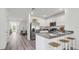 Open-concept kitchen with stainless steel appliances and breakfast bar seating, great for casual dining at 36155 Sunflower Hill Dr, Zephyrhills, FL 33541