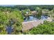 Aerial view of lush landscaping, pond, and nearby neighborhood at 3902 Shoreside Cir, Tampa, FL 33624