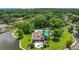 Aerial view of a community pool and clubhouse by a lake and lush greenery at 3902 Shoreside Cir, Tampa, FL 33624