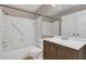 Bathroom with a white tiled shower and tub combination, updated sink, and a mirror at 3902 Shoreside Cir, Tampa, FL 33624