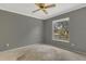 Bedroom with neutral paint, carpet, and a large window at 3902 Shoreside Cir, Tampa, FL 33624