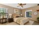 Staged bedroom with neutral paint, large window and ceiling fan at 3902 Shoreside Cir, Tampa, FL 33624