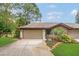Lovely home with a two-car garage, stone accents, and neatly manicured front yard at 3902 Shoreside Cir, Tampa, FL 33624