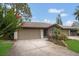 Beautiful home featuring a well-kept lawn, two-car garage, and stone-accented facade at 3902 Shoreside Cir, Tampa, FL 33624