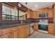 Well-lit kitchen features wood cabinets, granite countertops and stainless-steel appliances at 3902 Shoreside Cir, Tampa, FL 33624
