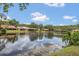 Picturesque view of homes by a calm lake reflecting the sky at 3902 Shoreside Cir, Tampa, FL 33624