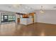 Open living area with hardwood floors, breakfast bar, and view of the screened-in lanai at 3902 Shoreside Cir, Tampa, FL 33624