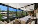 Cozy sunroom with plush seating and peaceful pond views at 3902 Shoreside Cir, Tampa, FL 33624