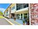 A welcoming entrance with brick columns, potted plants, and seating creates a charming first impression at 416 73Rd N Ave # 206, St Petersburg, FL 33702