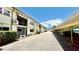 Exterior view showing building facade and carport parking, convenient access, and beautiful landscaping at 416 73Rd N Ave # 206, St Petersburg, FL 33702