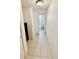 A long tiled hallway gives access to a bathroom at 416 73Rd N Ave # 206, St Petersburg, FL 33702