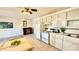 This kitchen features white appliances, a dining area, and a tiled floor at 416 73Rd N Ave # 206, St Petersburg, FL 33702