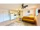 A cozy room with a couch, a dining area, a ceiling fan and a kitchen at 416 73Rd N Ave # 206, St Petersburg, FL 33702