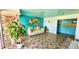 An inviting lobby features a vibrant painting, lush plant, and seating area for guests at 416 73Rd N Ave # 206, St Petersburg, FL 33702
