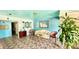 A communal lobby features comfortable seating, turquoise accent walls, and patterned tile flooring at 416 73Rd N Ave # 206, St Petersburg, FL 33702