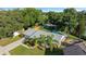 Aerial view of a house with a pool, backyard, and green surroundings, highlighting the outdoor living and leisure spaces at 4307 Foxglen Ln, Tampa, FL 33624