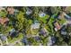 Aerial view of the property, surrounded by lush greenery in a suburban neighborhood, complete with multiple swimming pools at 4307 Foxglen Ln, Tampa, FL 33624