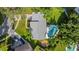 Aerial view highlighting property layout, including a pool and outdoor firepit, with ample yard space and well manicured greenery at 4307 Foxglen Ln, Tampa, FL 33624