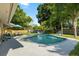 Beautiful backyard features a sparkling pool, lush landscaping, and plenty of room for entertaining at 4307 Foxglen Ln, Tampa, FL 33624
