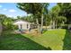 Lush backyard featuring a well-maintained lawn, pool, and outdoor seating, creating the perfect setting for relaxing at 4307 Foxglen Ln, Tampa, FL 33624