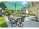 Inviting backyard oasis featuring a sparkling pool, covered seating area, and lush tropical landscaping at 4307 Foxglen Ln, Tampa, FL 33624