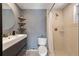 Updated bathroom features a tiled shower, modern vanity, and decorative shelves at 4307 Foxglen Ln, Tampa, FL 33624
