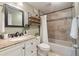 Charming bathroom with decorative shelves, granite countertop, and a shower-tub combination at 4307 Foxglen Ln, Tampa, FL 33624
