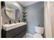 Stylish bathroom with modern vanity, round mirror, and decorative shelving, offering a sleek and functional design at 4307 Foxglen Ln, Tampa, FL 33624