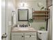 Well-lit bathroom with a modern vanity, decorative shelves, and neutral color scheme at 4307 Foxglen Ln, Tampa, FL 33624