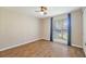 Cozy bedroom with hardwood floors, a ceiling fan, and a window with blue curtains at 4307 Foxglen Ln, Tampa, FL 33624