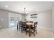 Chic dining room with modern chandelier and access to the backyard and pool via sliding glass doors at 4307 Foxglen Ln, Tampa, FL 33624