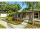 The welcoming front entrance features a white door with decorative wreath and a neatly landscaped garden bed at 4307 Foxglen Ln, Tampa, FL 33624