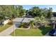 Landscaped front yard features palm trees and a well-maintained lawn leading to a charming single-story home with an attached garage at 4307 Foxglen Ln, Tampa, FL 33624