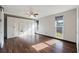 Spacious main bedroom featuring hardwood floors, ceiling fan, two large windows and custom built-in wardrobe and storage at 4307 Foxglen Ln, Tampa, FL 33624