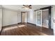 Bright main bedroom featuring hardwood floors, ceiling fan, double closets, and a barn door entry to the bathroom at 4307 Foxglen Ln, Tampa, FL 33624