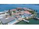 An aerial view of a beautiful home with a pool on the water and a private dock at 451 Palm Ne Is, Clearwater Beach, FL 33767