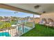 Relaxing balcony space overlooking water with synthetic turf, seating, and views of the community at 451 Palm Ne Is, Clearwater Beach, FL 33767