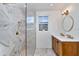 Modern bathroom with walk-in shower, dual sinks, wood cabinets, and stylish fixtures at 451 Palm Ne Is, Clearwater Beach, FL 33767