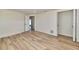 Spacious bedroom showcasing light wood floors, neutral walls, and a pair of open doorways at 451 Palm Ne Is, Clearwater Beach, FL 33767