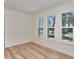 Bright bedroom with wood flooring and large windows with neighborhood views at 451 Palm Ne Is, Clearwater Beach, FL 33767